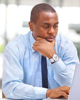 Picture of a man working on a laptop for Raleigh ACA Obama Care health insurance help from Hunt Insurance.