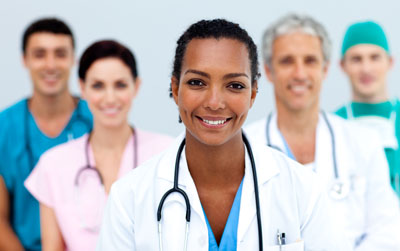 Photo of five medical professionals with an african american doctor in the front for information on Raleigh concierge medicine and direct primary care, from Hunt Insurance.