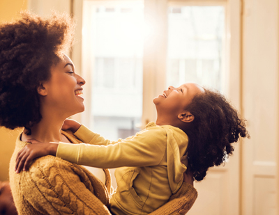 African American mom playing with her young daughter; for information on North Carolina life insurance from John Hunt of Raleigh.