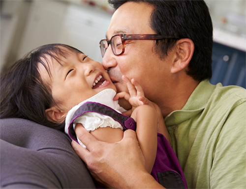 Asian man and daughter playing; for information on a term life insurance quote in Raleigh, NC from Hunt Insurance