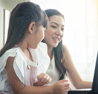 Young Asian mom and duagher looking at a computer